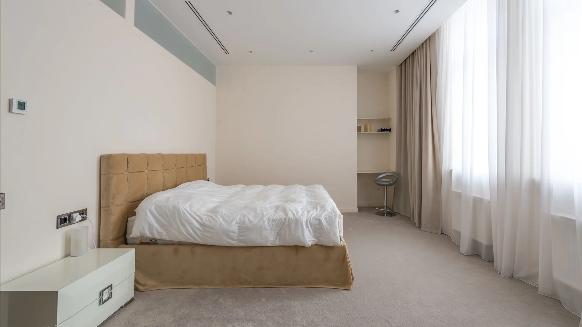 A calm bedroom with natural textures and soft daylight